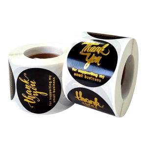 Detail of black round Thank You stickers with gold foil for small business packaging