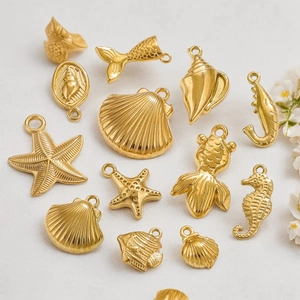 Golden stainless steel ocean theme charms set with starfish and seashell pendants