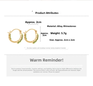 Detail view of gold-tone C-shape earrings featuring green rhinestones with 2cm x 2cm dimensions