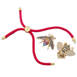 Adjustable red woven Milan cord bracelet with two gold bee charms and crystal inlays
