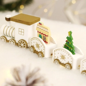Festive Christmas wooden train decoration with snowy scenes and holiday motifs on a table