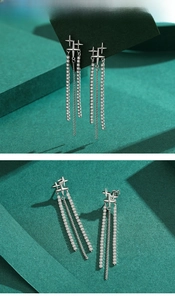Macro detail of S925 sterling silver long tassel earrings with sparkling star stud and zircon