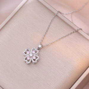 Silver four-leaf clover necklace with pink and white zircon stones in jewelry box