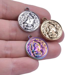 Close-up of lion head embossed pendants in silver, gold, and rainbow vacuum plating