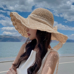 Summer wide brim straw sun hat with white lace ribbon bow and pearl accents