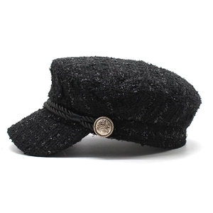 Classic black tweed newsboy cap with gold emblem button and braided rope detail
