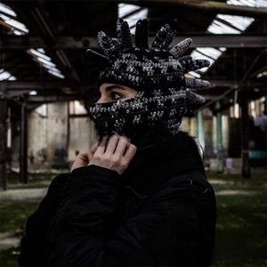 Detail of handmade knit balaclava featuring punk mohawk spikes and black-white waves