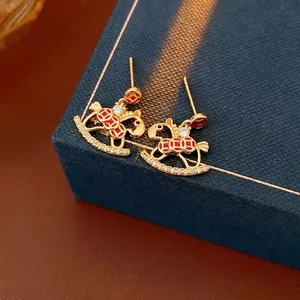 Exquisite gold-plated rocking horse earrings with red patterns and white zircon stones