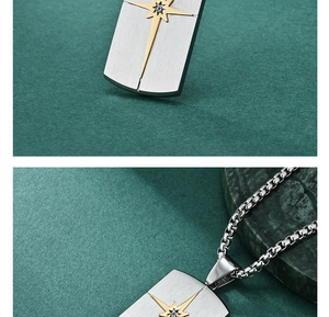 Detail of silver brushed stainless steel necklace with golden star and clear gemstone