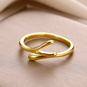 Macro shot of gold plated teardrop knot ring showing the polished fluid metal texture