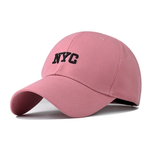 Close-up of pink cotton baseball cap featuring black NYC 3D letter embroidery detail