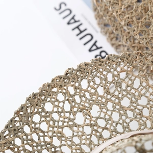 Handcrafted woven seagrass sun hat with breathable hollow mesh and a flat top crown