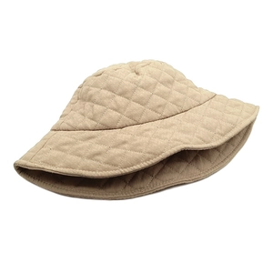 Close-up of khaki quilted bucket hat showing fine diamond stitching and textured fabric