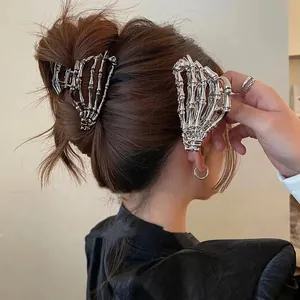 Silver skeleton hand hair claws for women in gothic style on brown hair bun set of two