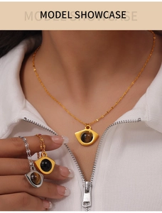 Macro detail of eye-shaped hollow pendant necklace with natural tiger eye stone inlay