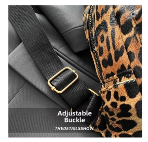Close-up of leopard print backpack showing adjustable gold metal buckle and nylon strap