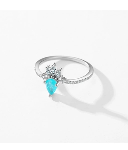 Detail of pear-shaped turquoise stone and sparkling crystals on silver crown ring