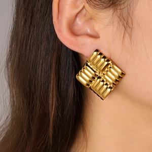 Detail showing the textured 18K gold-plated stainless steel square hoop earring on ear