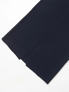 Detailed view of premium navy blue dense knit fabric texture on a midi skirt