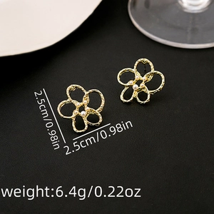 Detailed macro view of golden flower earrings with white pearl center and size specs