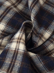 Macro shot of navy and brown plaid flannel fabric with soft brushed texture