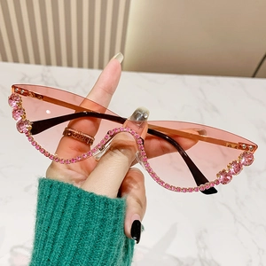 Modern cat-eye sunglasses with pink rhinestones and semi-transparent lenses for women