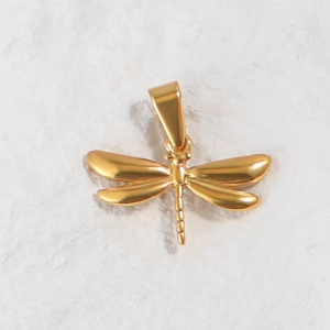 Macro shot of 24K gold plated dragonfly pendant with polished metallic finish and bale