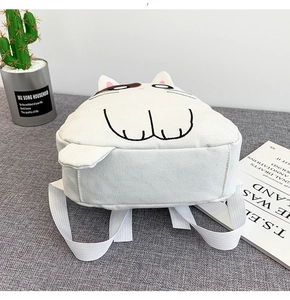 Detail of white canvas backpack featuring cute 3D cat ears and embroidered kitten design