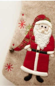 Detail of Santa Claus patchwork embroidery with small bell on beige felt Christmas stocking