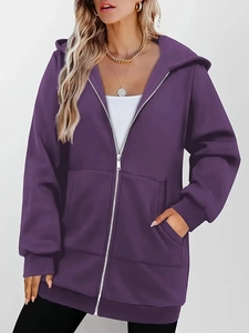 Detail of purple zip-up hoodie featuring ribbed cuffs and metal zipper texture