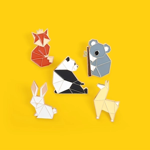 Geometric animal enamel pin set featuring fox panda and koala on a yellow backdrop