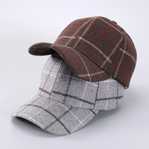 Detailed close-up of textured houndstooth fabric on vintage brown and grey baseball caps