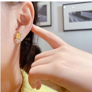 Detailed side view of rectangular yellow crystal earrings with marquise-cut accents
