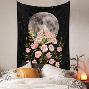 Detail of moon phase tapestry with pink floral design against a starry black backdrop
