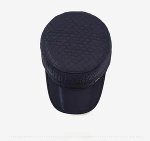 Top view of quilted winter flat cap with diamond stitching and metal side badge detail