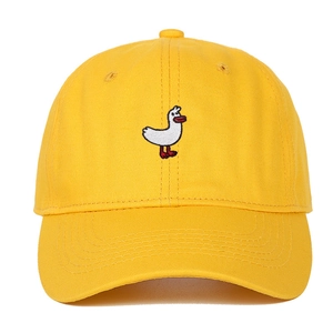 Detailed close-up of yellow cotton baseball cap with white duck embroidery on front