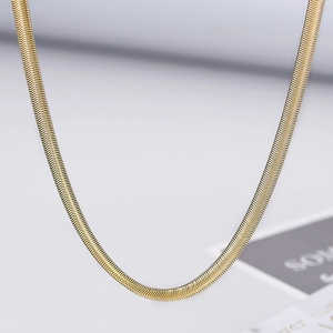 Detail shot of a 5mm flat snake bone chain with polished gold finish and textured weave