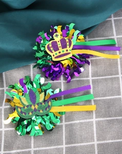 Detail of Mardi Gras carnival crown hair clip with purple green and gold sequin tassels