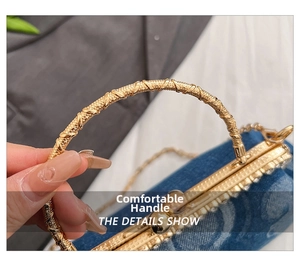 Close-up of golden woven texture handle and metal clasp on denim fabric handbag