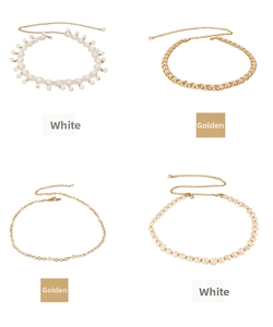 Detail of four distinct pearl and shell waist chains in gold and white finishes