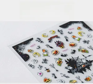 Macro detail of Halloween 5D nail stickers featuring pumpkins, ghosts, and spider webs