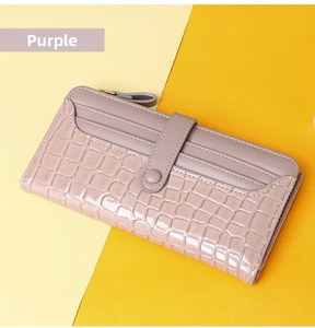Detail view of purple long wallet featuring crocodile pattern texture and card slots