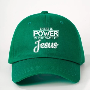 Green baseball cap with white 'Power in the Name of Jesus' print and adjustable strap