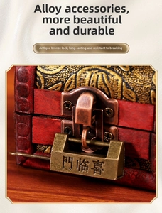 Macro detail of retro bronze alloy latch and padlock on vintage red wooden jewelry box