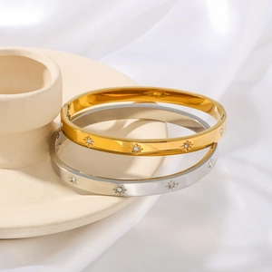 Minimalist eight-pointed star diamond bracelets in polished gold and silver finishes