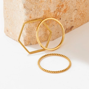 Three-piece gold stainless steel geometric ring set with smooth and twisted textures