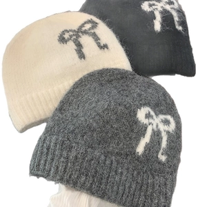 Winter knitted wool beanie set with bow pattern in white, grey, and black colors