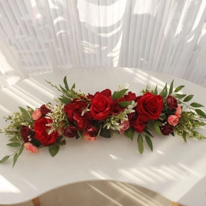 Detail view of long artificial rose floral arrangement with red and pink roses for wedding