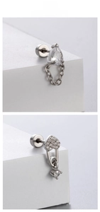 Detail of silver heart and teardrop stud earrings with delicate hanging chains