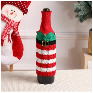 Close-up of knitted Christmas wine bottle cover with bell detail and striped pattern